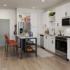 Kitchen with white cabinets and bar stools